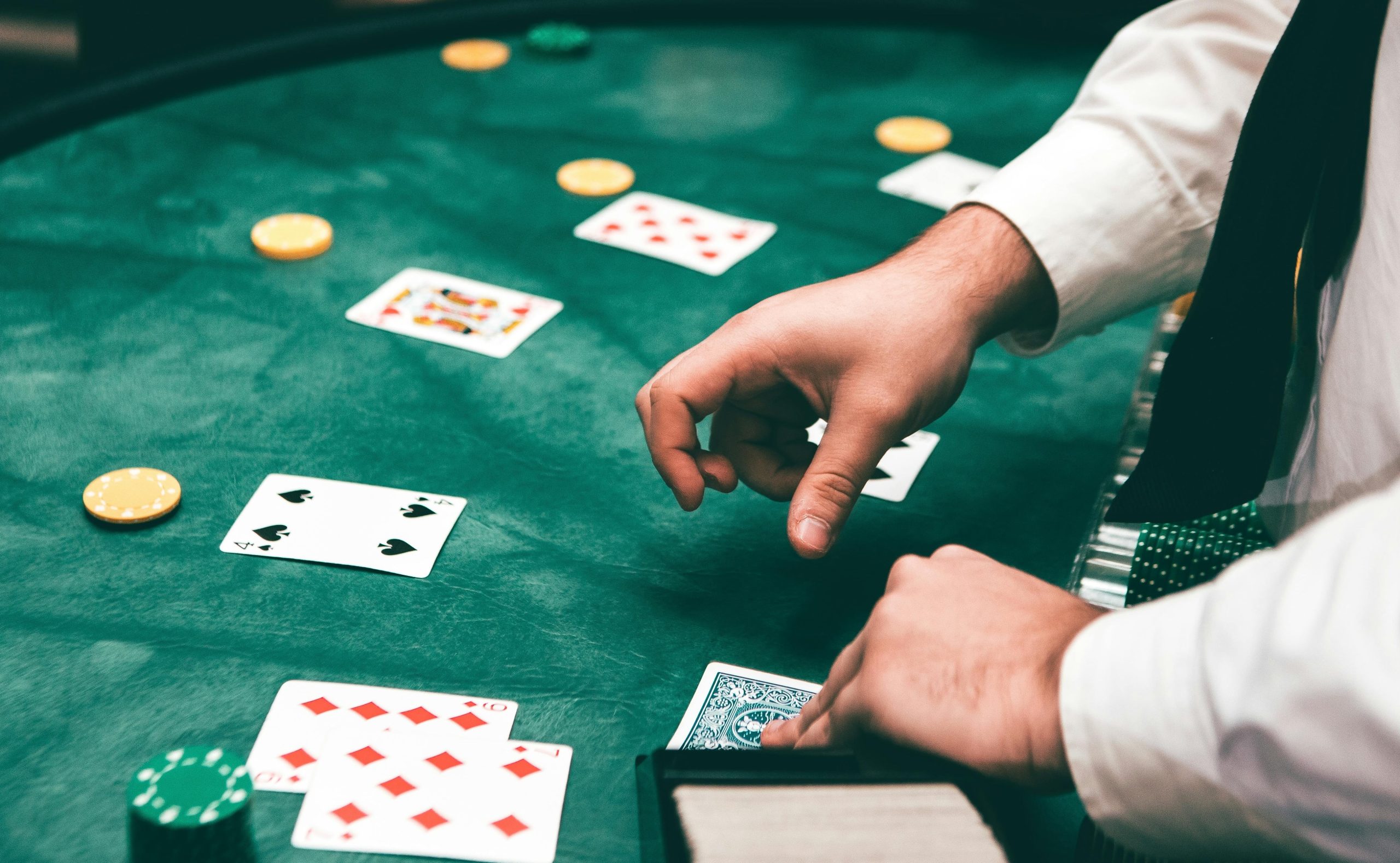 Video poker table, dealing cards to players.