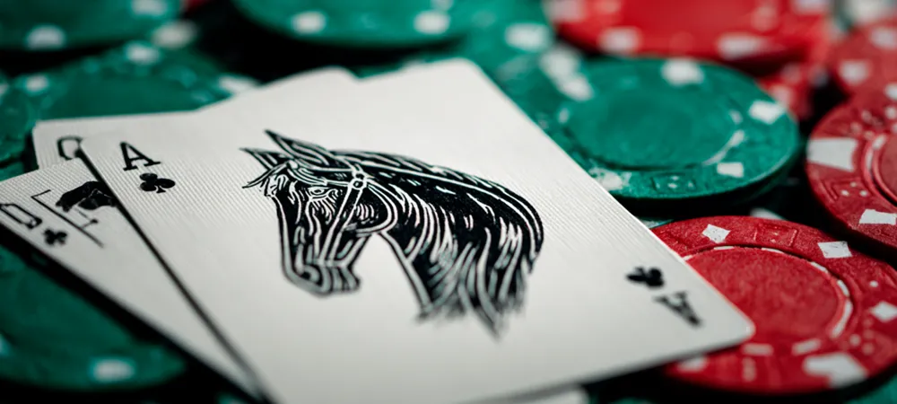 a playing card with a horse on it laid on top of poker chips